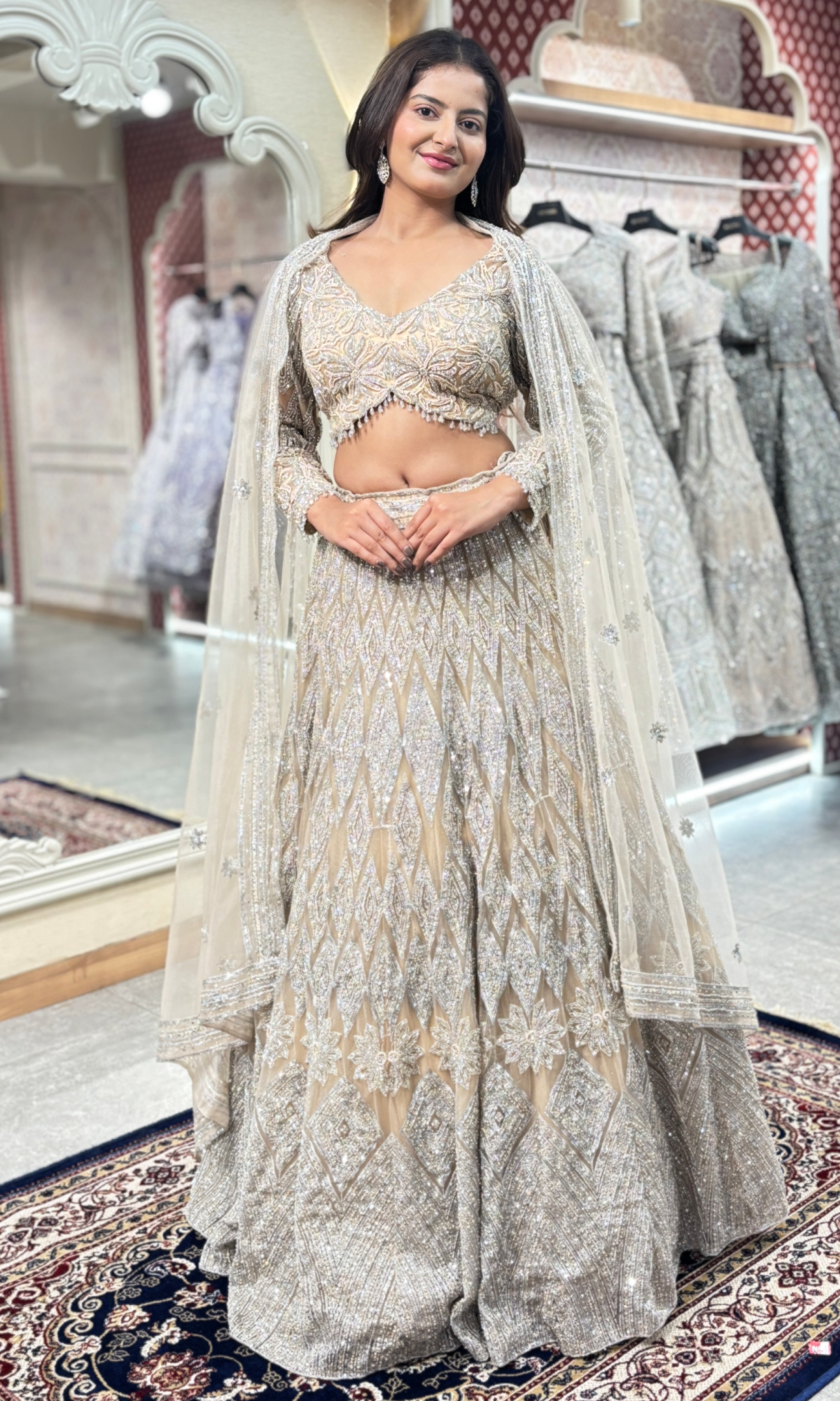 Cream Net Ethnic Motifs Lehenga With Stitched Blouse