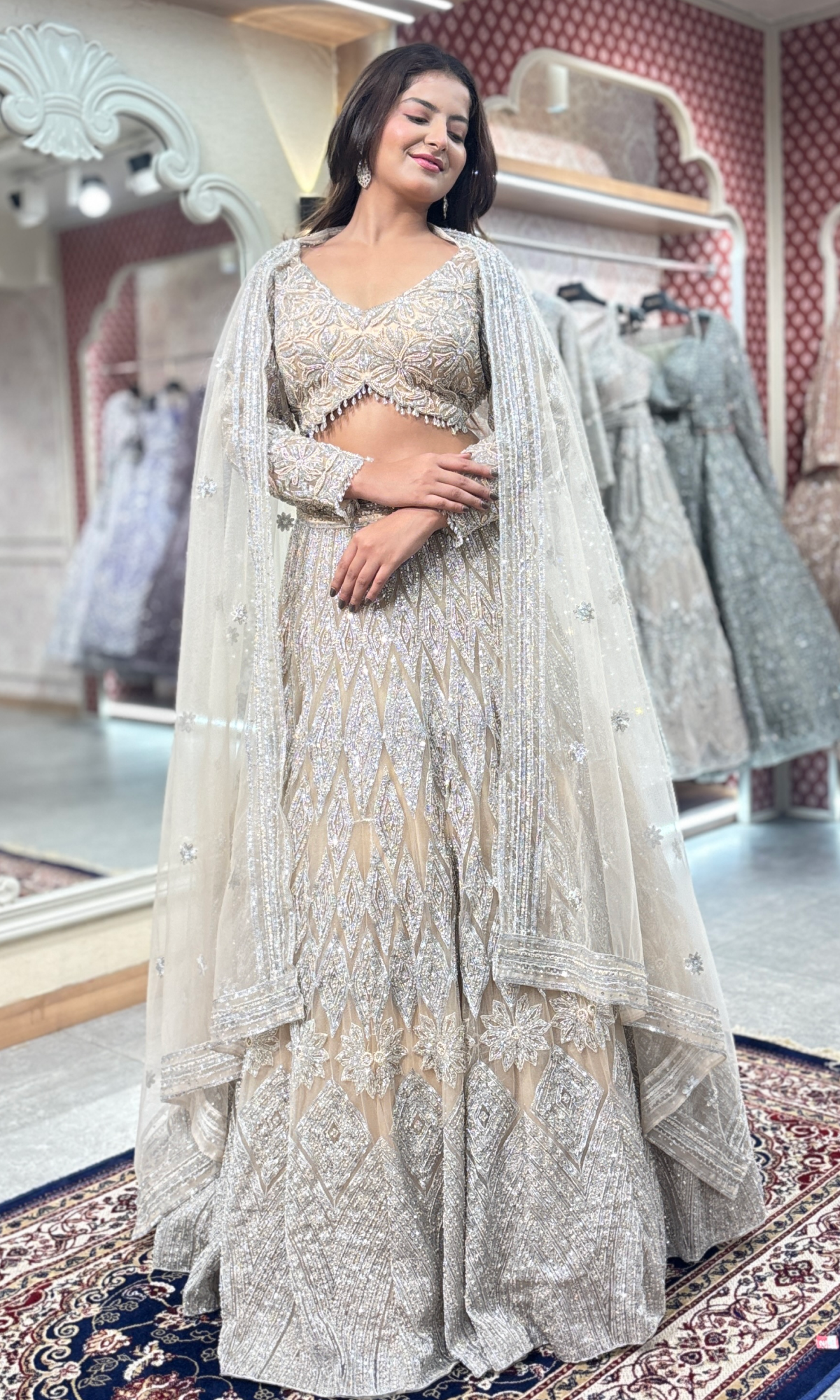 Cream Net Ethnic Motifs Lehenga With Stitched Blouse