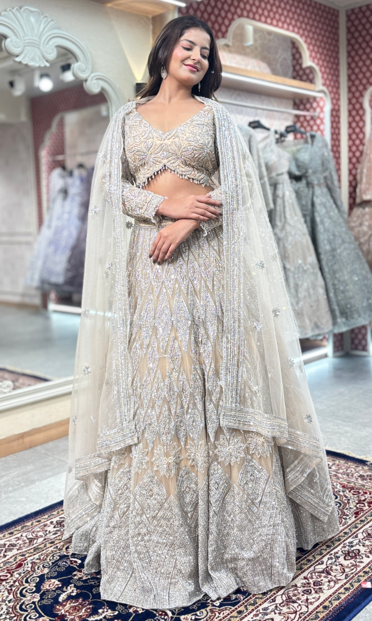 Cream Net Ethnic Motifs Lehenga With Stitched Blouse