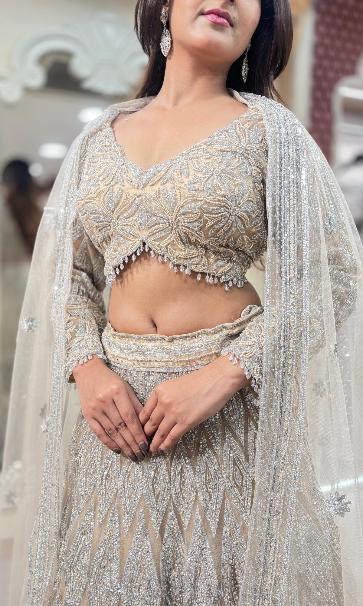 Cream Net Ethnic Motifs Lehenga With Stitched Blouse